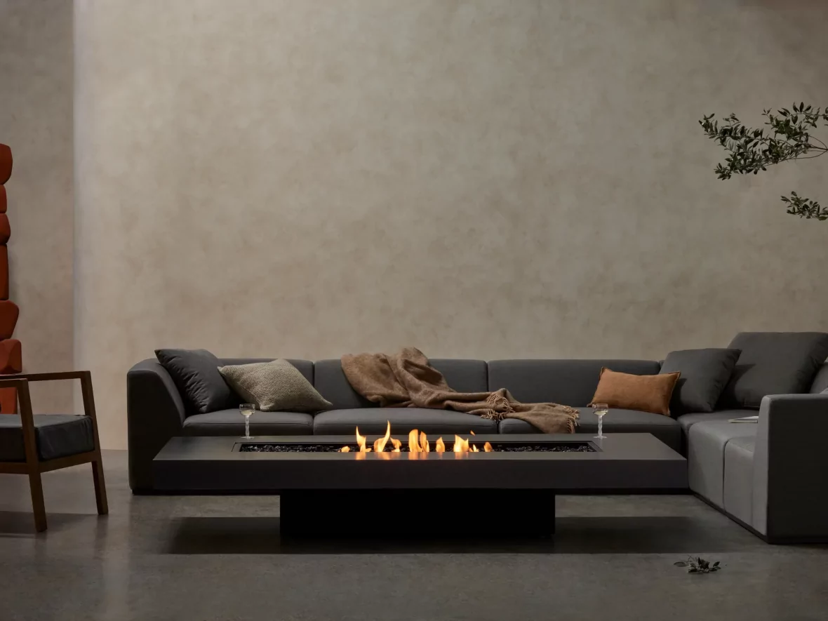 EcoSmart Fire Gin 90 fire table in front of an outdoor sofa