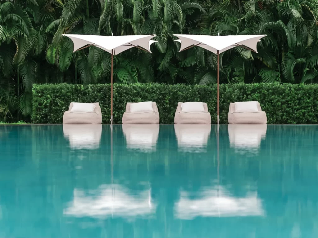 Tuuci parasols by a swimming pool